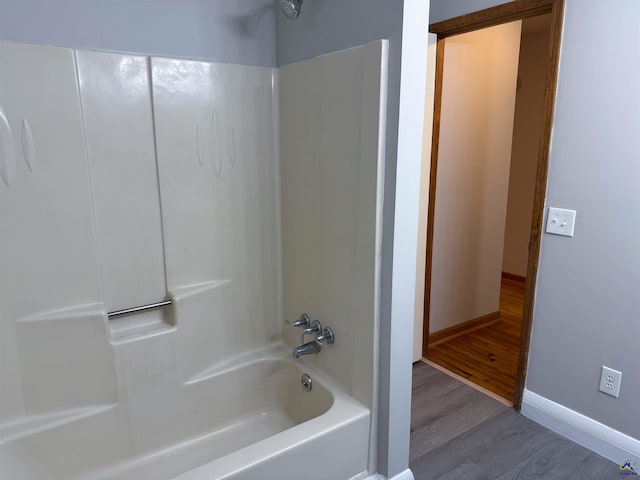 bathroom featuring tub / shower combination and hardwood / wood-style flooring