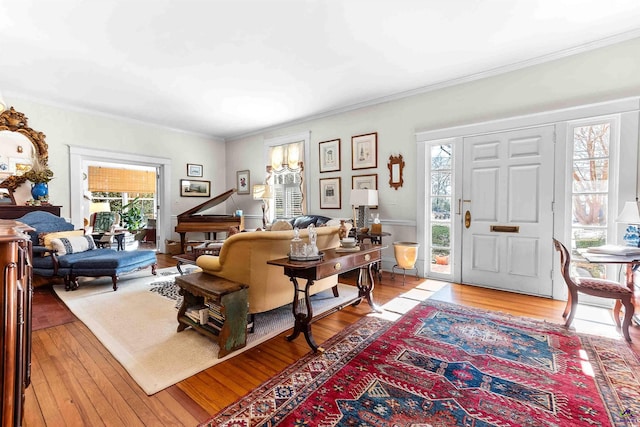 living room with light hardwood / wood-style floors and ornamental molding