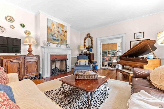 living room with crown molding and light hardwood / wood-style flooring