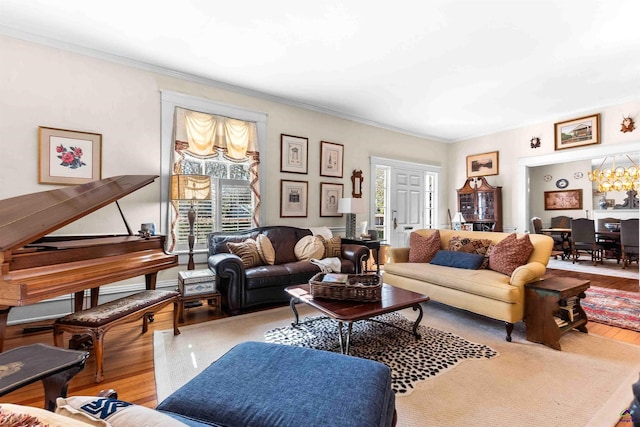 living room with an inviting chandelier, crown molding, and hardwood / wood-style flooring