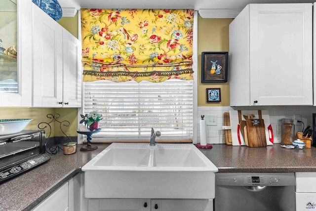 kitchen featuring stainless steel dishwasher, backsplash, white cabinets, and sink