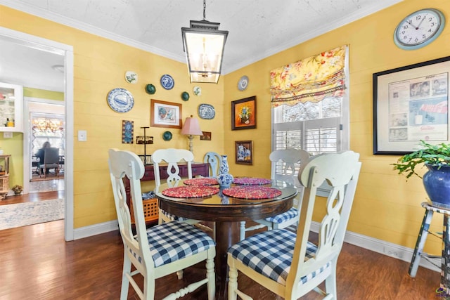 dining space featuring dark hardwood / wood-style flooring and crown molding