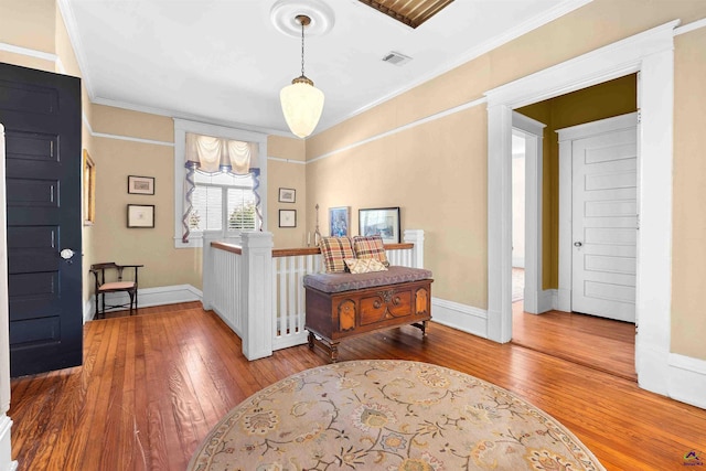 foyer with ornamental molding and hardwood / wood-style floors