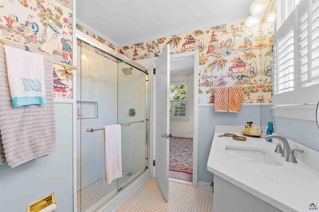 bathroom with vanity and a shower with door