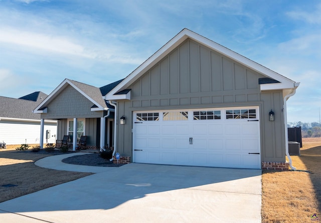 view of front of home with a garage and central air condition unit