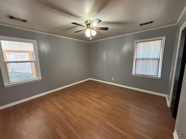 570 Perry Hwy, Hawkinsville, GA 31036 - spare room with dark wood-type flooring, plenty of natural light, ornamental molding, and ceiling fan
