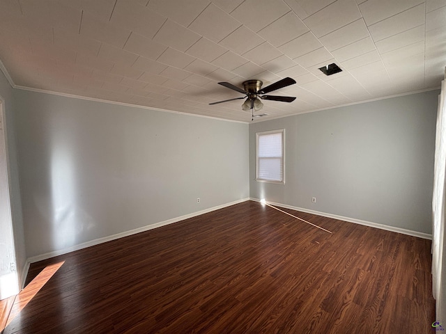 empty room with ceiling fan, dark hardwood / wood-style flooring, and crown molding