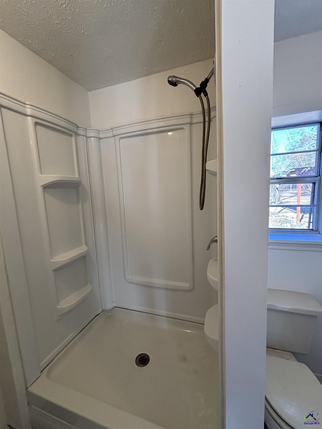 570 Perry Hwy, Hawkinsville, GA 31036 - bathroom featuring a textured ceiling, toilet, and walk in shower
