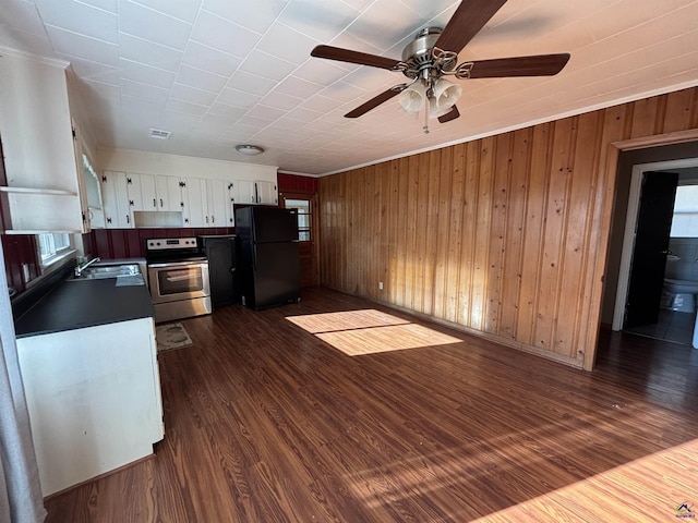 570 Perry Hwy, Hawkinsville, GA 31036 - kitchen with sink, white cabinetry, dark wood-type flooring, stainless steel range with electric stovetop, and black refrigerator