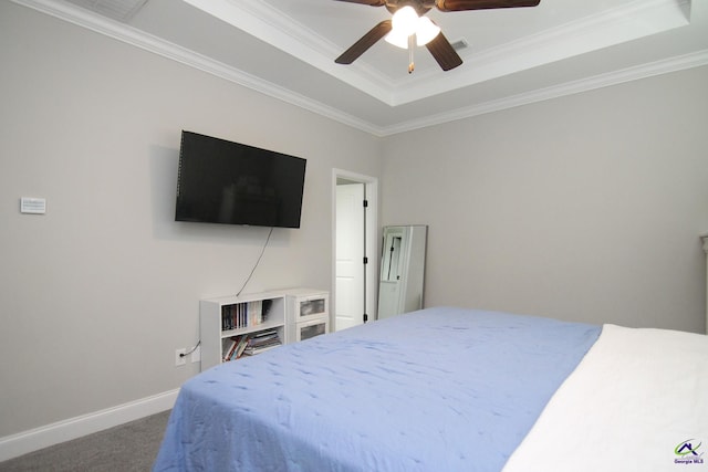 bedroom with ceiling fan, crown molding, a raised ceiling, and carpet floors