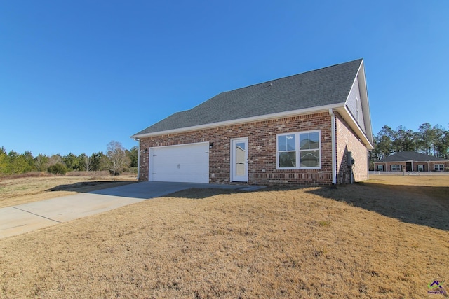 view of front of property with a front lawn and a garage