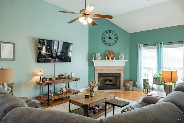 living room featuring ceiling fan, vaulted ceiling, and wood-type flooring