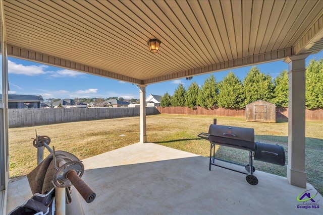 view of patio featuring area for grilling and a storage unit