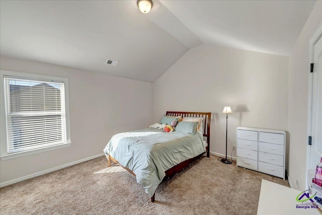 carpeted bedroom with vaulted ceiling