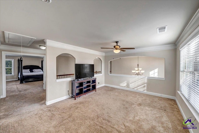 living room featuring ornamental molding, a healthy amount of sunlight, ceiling fan with notable chandelier, and carpet floors