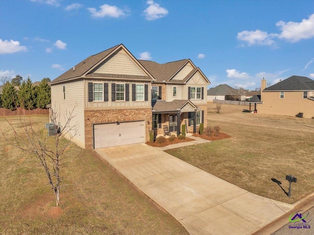 craftsman-style home featuring a front lawn, a garage, cooling unit, and covered porch