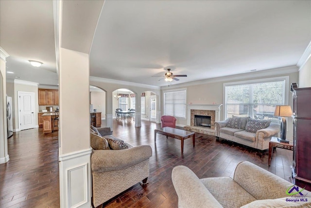 living room with dark wood-type flooring and ornamental molding