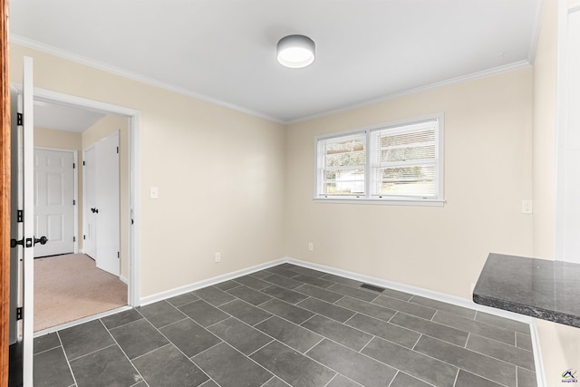 carpeted empty room featuring ornamental molding