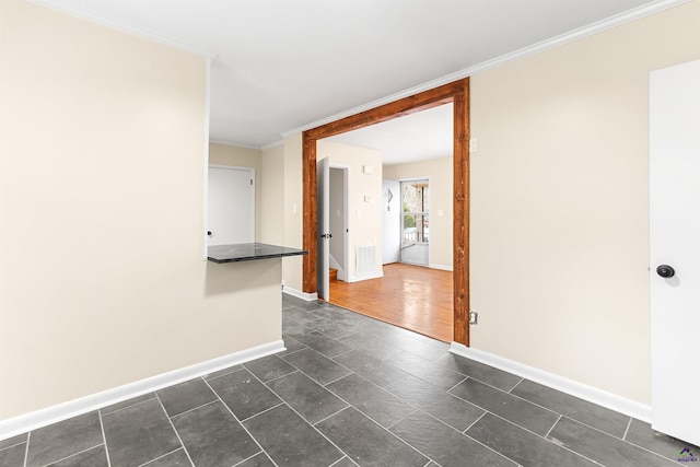 unfurnished room featuring crown molding