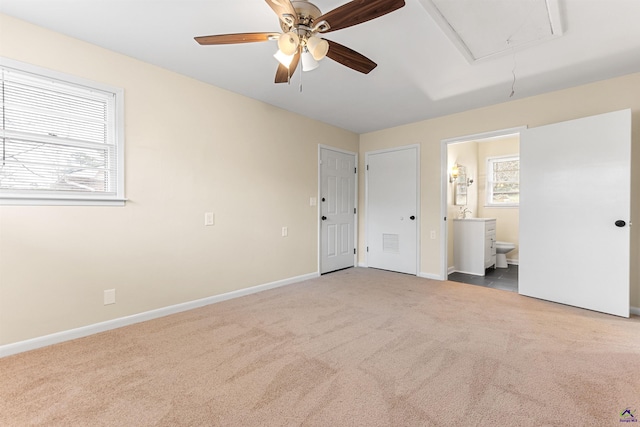 unfurnished bedroom featuring ceiling fan, carpet, and connected bathroom