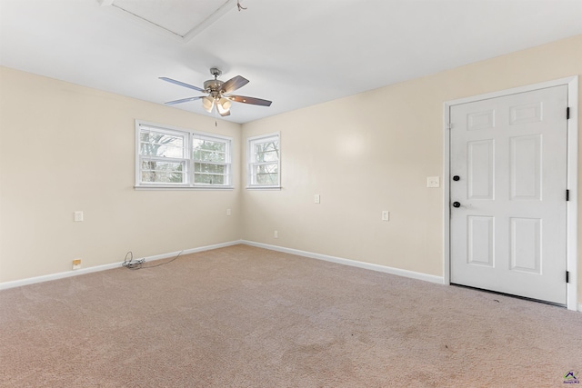 spare room featuring ceiling fan and carpet