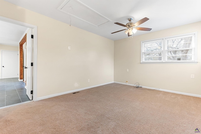 unfurnished room with ceiling fan and dark colored carpet