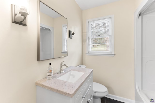 bathroom featuring toilet, vanity, and tile patterned flooring