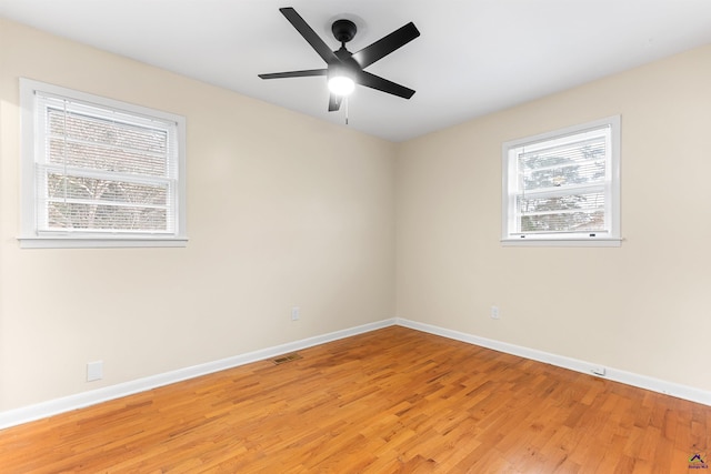 empty room with ceiling fan and light wood-type flooring