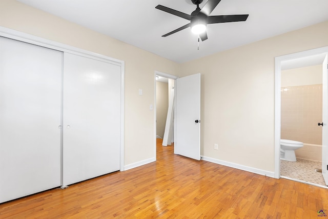 unfurnished bedroom with ceiling fan, a closet, connected bathroom, and light hardwood / wood-style floors