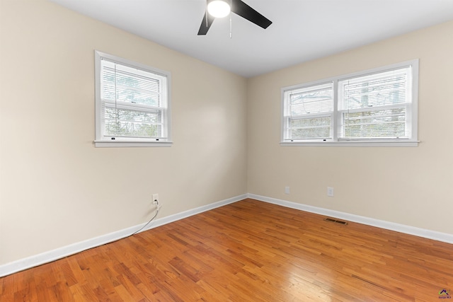 empty room with ceiling fan and hardwood / wood-style floors