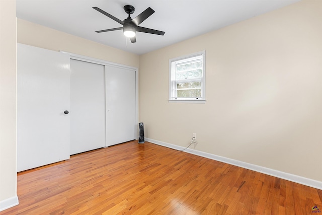 unfurnished bedroom with ceiling fan, light hardwood / wood-style floors, and a closet