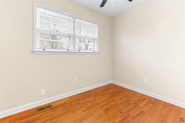 spare room featuring hardwood / wood-style flooring and ceiling fan