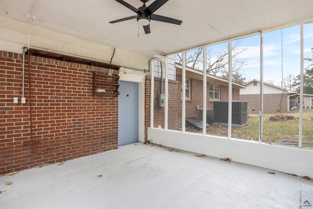 unfurnished sunroom featuring ceiling fan