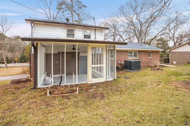 back of house with a sunroom, central AC unit, and a yard