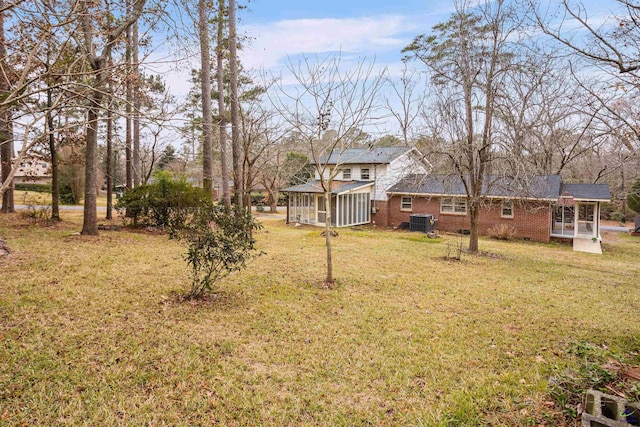 view of yard with cooling unit and a sunroom