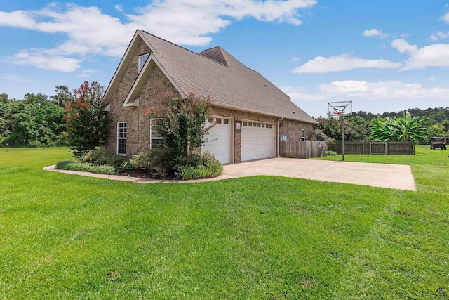 view of side of home with a garage and a yard