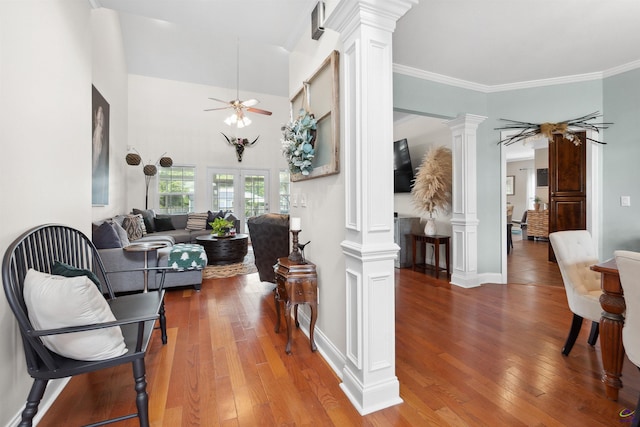 living room with decorative columns, hardwood / wood-style flooring, ceiling fan, and ornamental molding