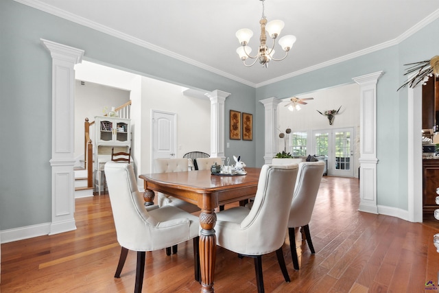 dining room with decorative columns, a chandelier, ornamental molding, and light hardwood / wood-style floors