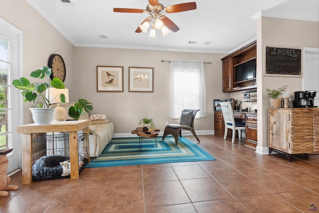 sitting room with dark tile patterned flooring, ceiling fan, and ornamental molding