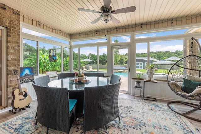 sunroom with ceiling fan and a healthy amount of sunlight