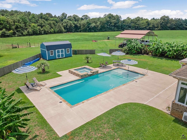 view of pool featuring an in ground hot tub, a patio, a lawn, and a shed