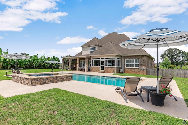 view of pool featuring a lawn, an in ground hot tub, and a patio