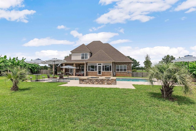 rear view of house featuring a fenced in pool, a yard, and a patio