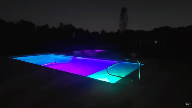 view of pool at night