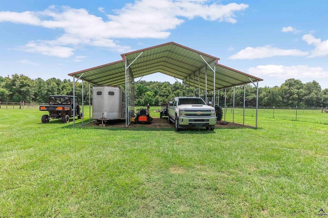 view of vehicle parking with a yard and a carport