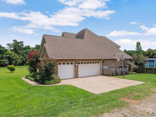 view of side of property with a garage and a lawn