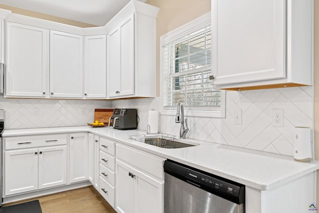 kitchen featuring light hardwood / wood-style floors, sink, white cabinetry, and dishwasher