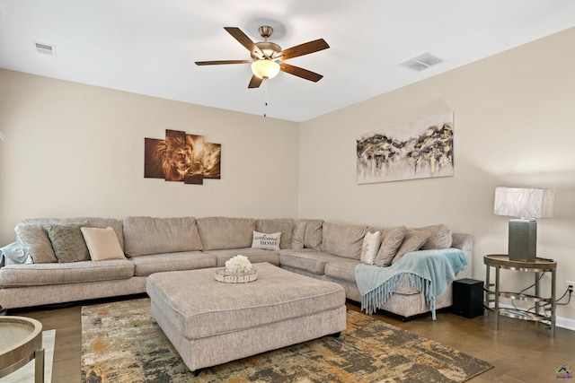 living room with ceiling fan and dark hardwood / wood-style flooring