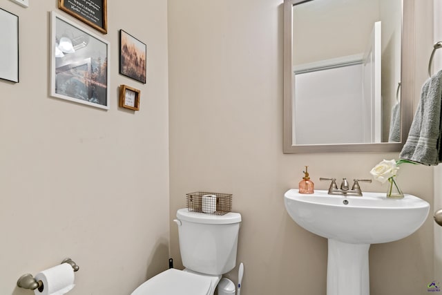 bathroom featuring sink and toilet