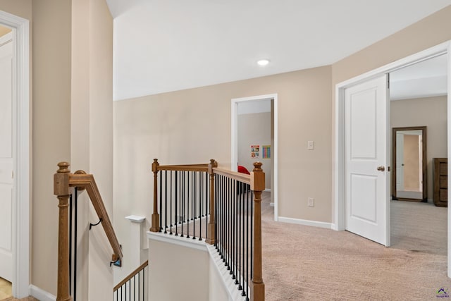 hall featuring light colored carpet